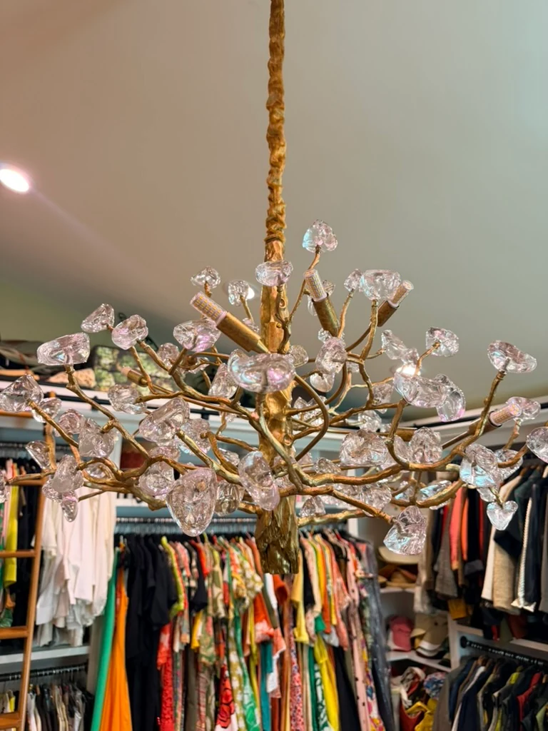 Close view of the branching gold chandelier and its clear decorative pieces