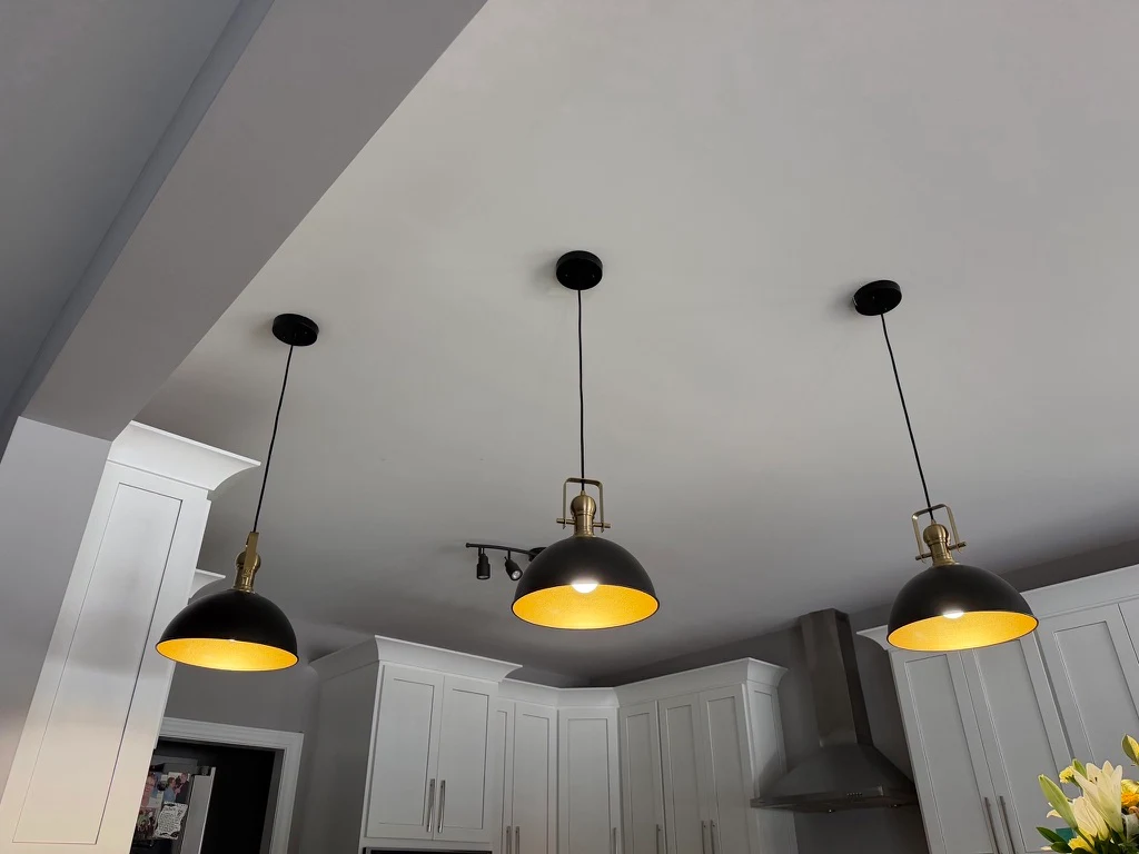 Three illuminated pendants above the kitchen island.