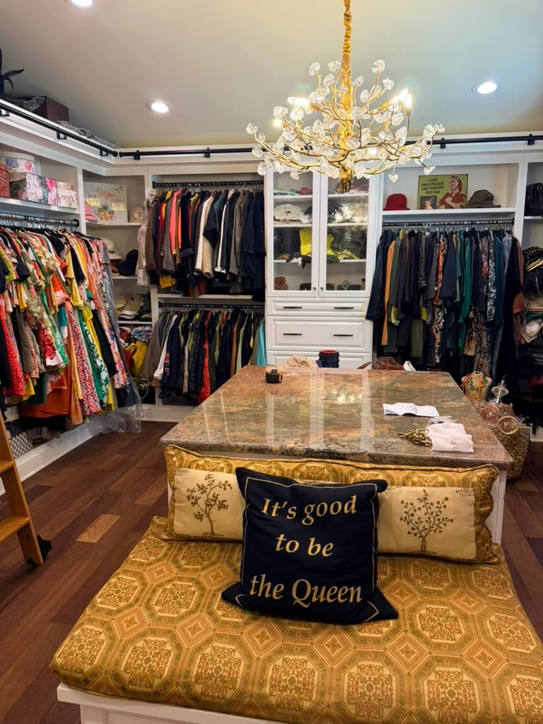 Gold chandelier installed above a dressing-room island