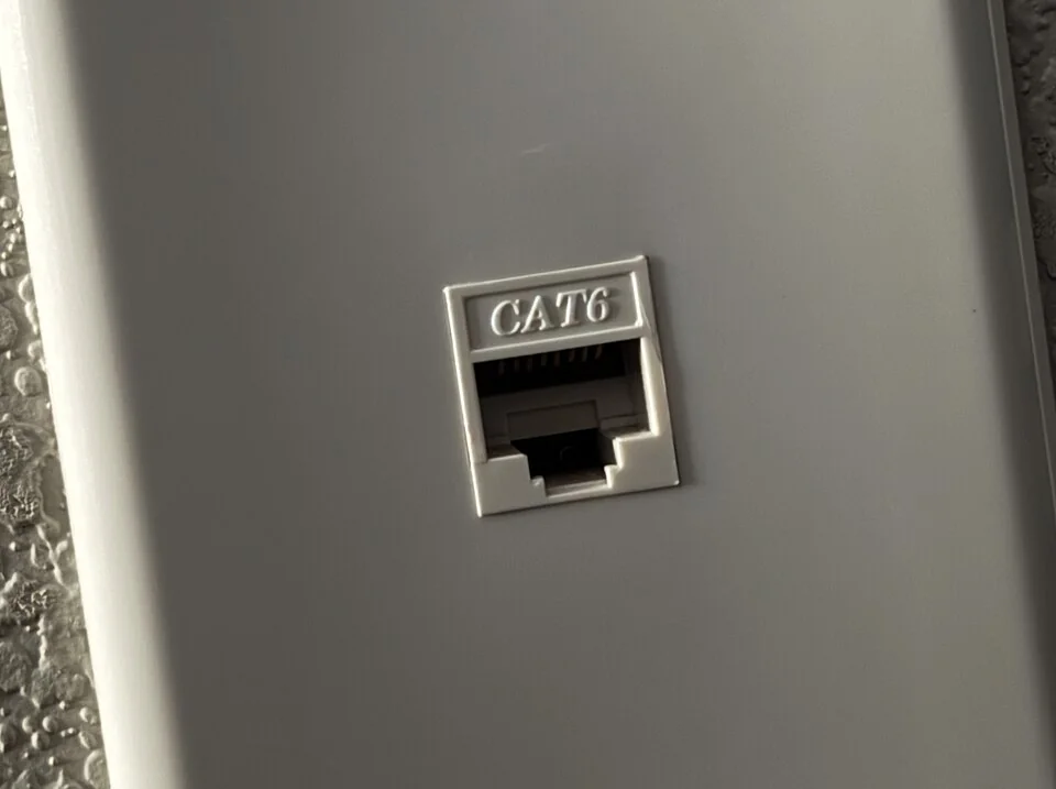 A single CAT6 Ethernet data jack on a gray wall plate.