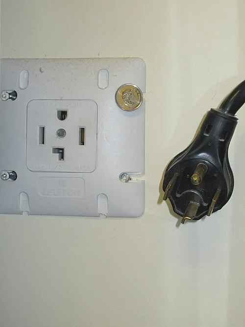Four-slot NEMA 14-30 dryer receptacle and matching plug. This is a dryer-specific connection.