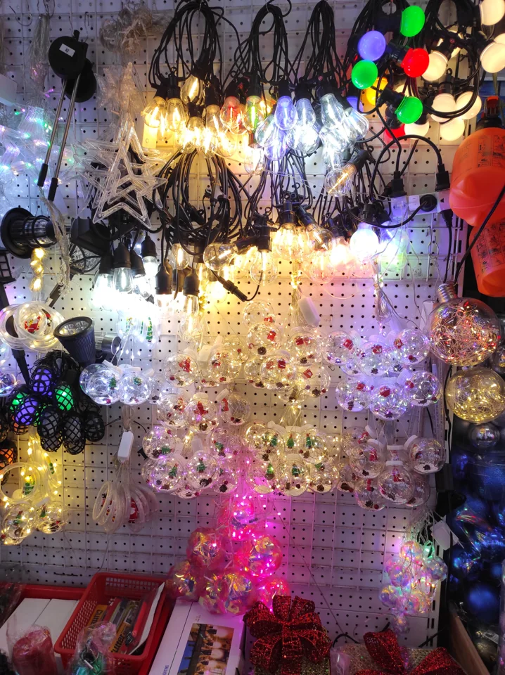 Display of illuminated seasonal string lights in several colors and shapes.