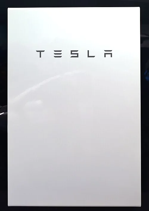 White Tesla Powerwall 2 home battery mounted on a wall.