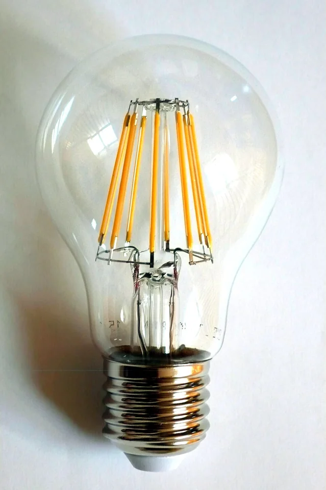 Clear screw-base LED bulb with visible yellow LED filaments.
