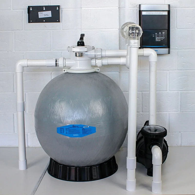 Pool equipment display with a wall-mounted ChloroMatic chlorinator controller above a filter and pump.