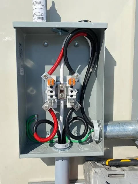Open electrical disconnect enclosure showing internal conductors. Reference photograph; leave protective covers in place.
