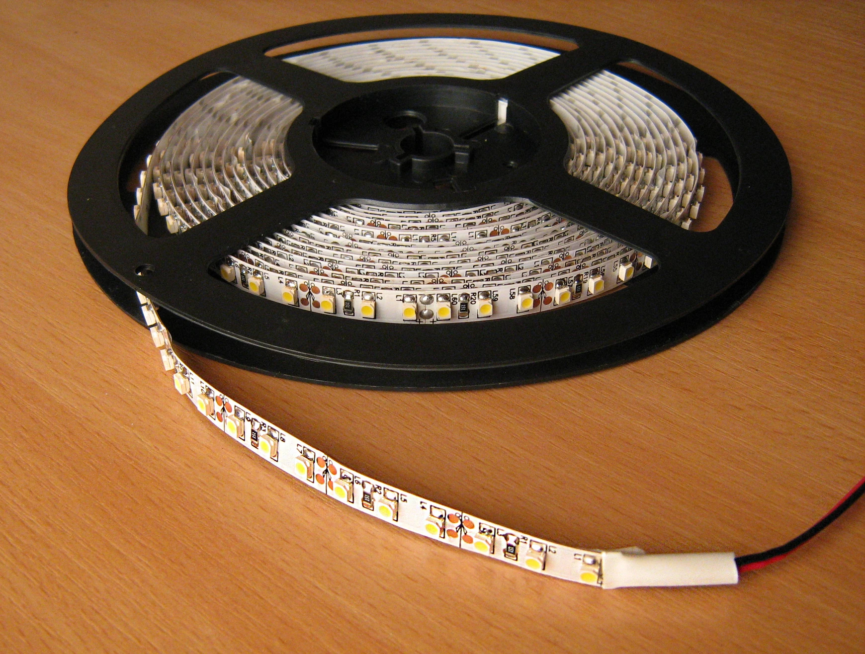 LED strip lighting partly unrolled from a reel — licensed reference photograph; not an installed kitchen project.