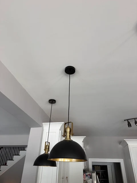 Black, brass & balance. The pendant fixtures photographed with the lights off.