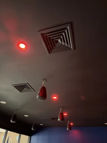 Accent lighting. Red accent lights and ceiling fixtures in a commercial space.