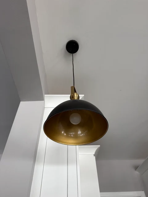 Under the shade. A view of the pendant shade’s gold interior with the light off.