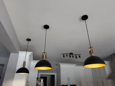 A different perspective. An angled view of the illuminated kitchen pendant installation.