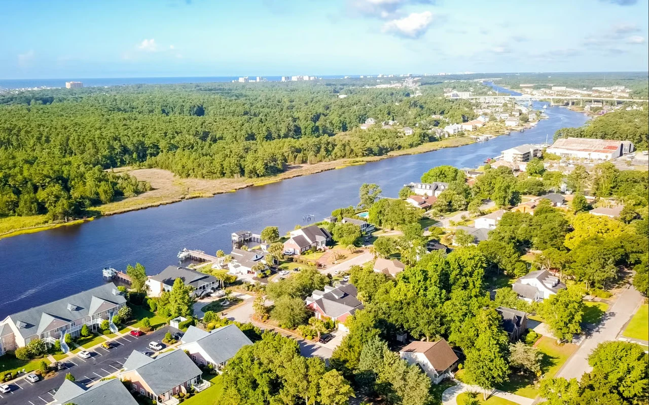 Aerial view of waterfront homes and the waterway in Little River