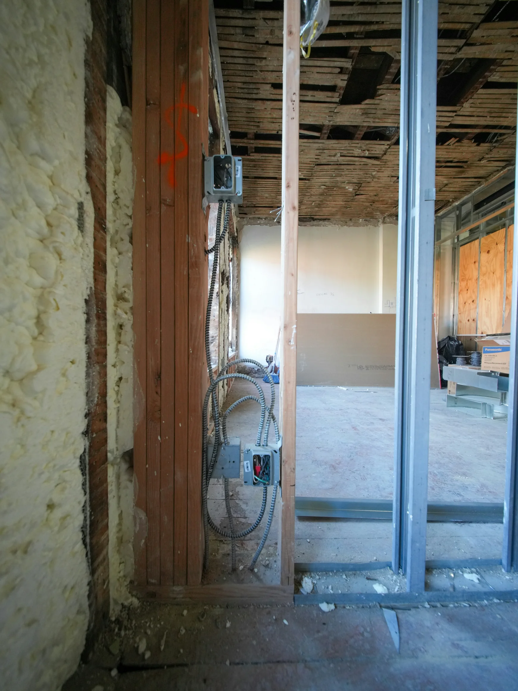 Construction site with exposed wiring and insulation — stock photograph