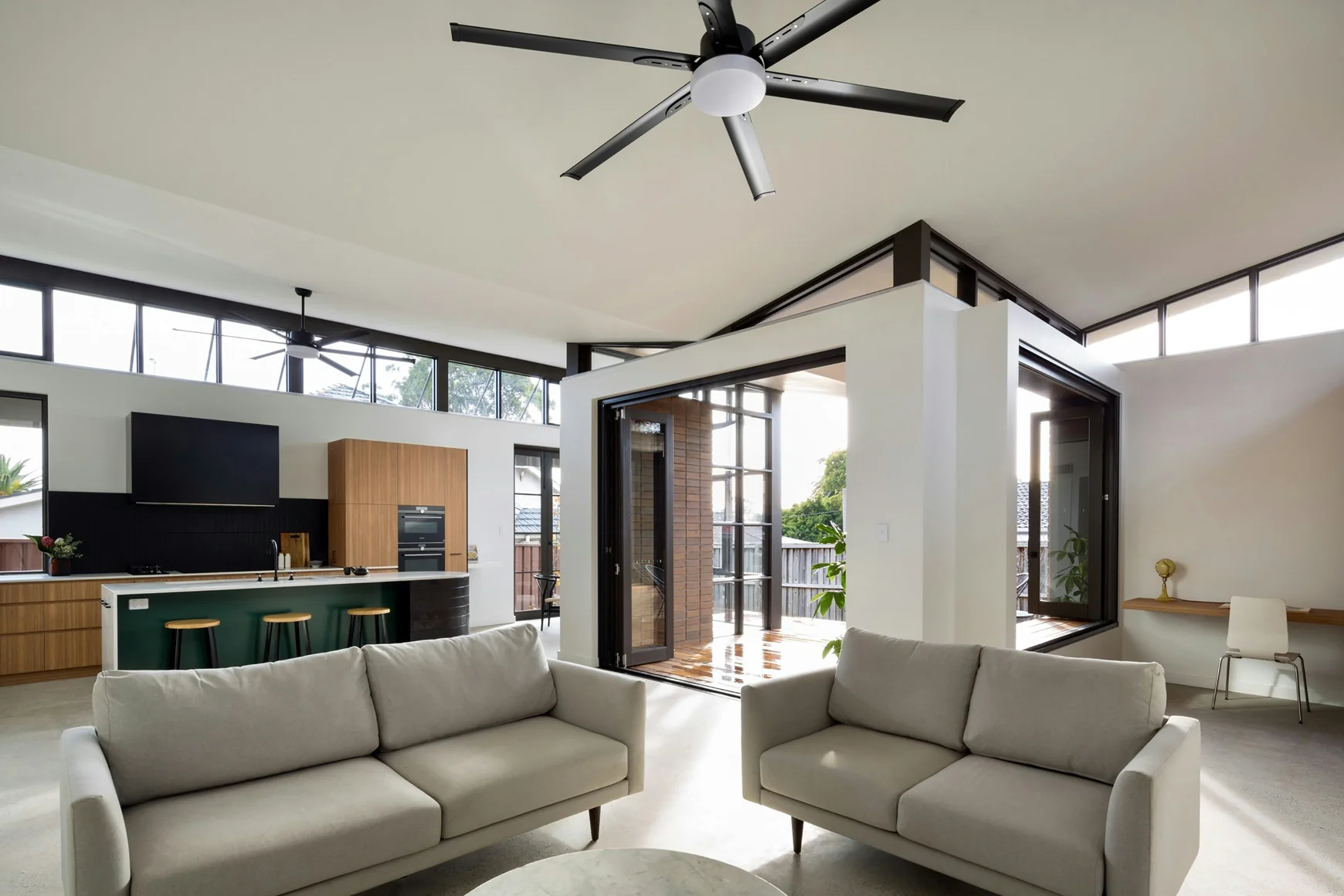 a living room with a large ceiling fan — stock photograph